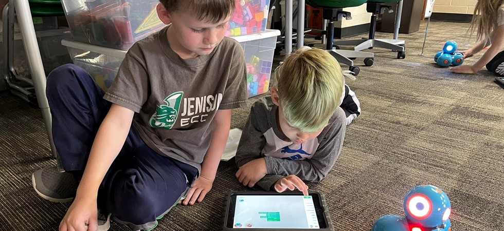 Two students learning on ipad