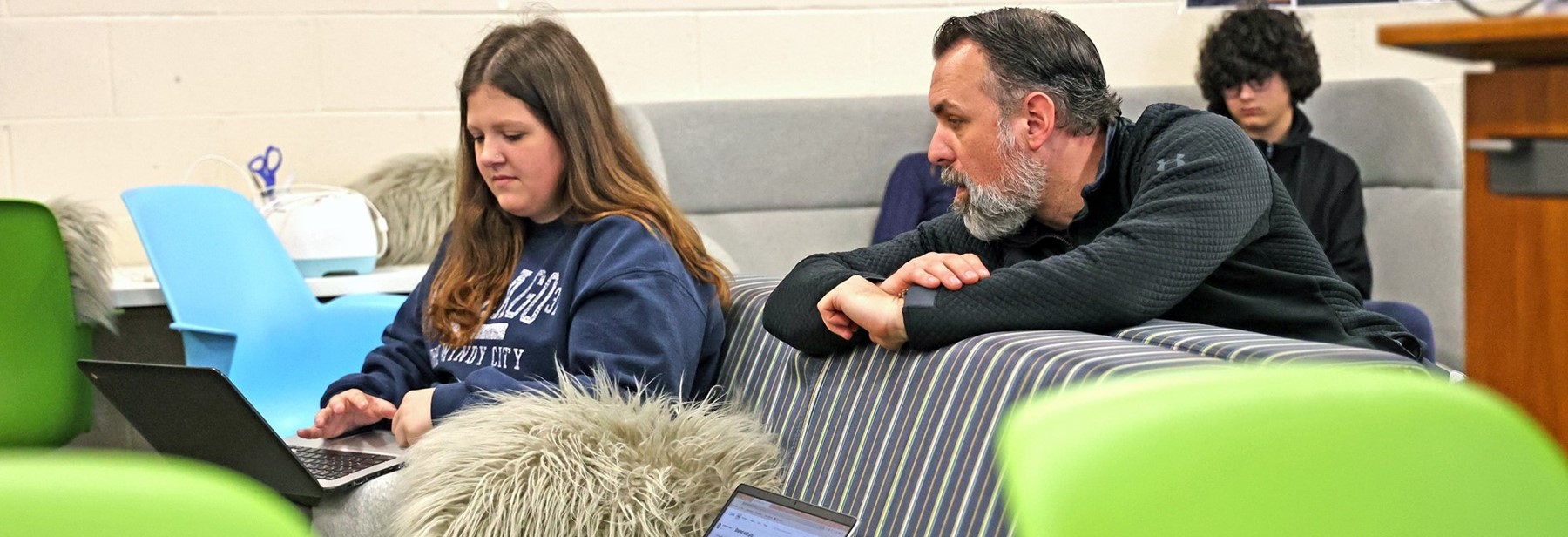 Teacher working with student in classroom