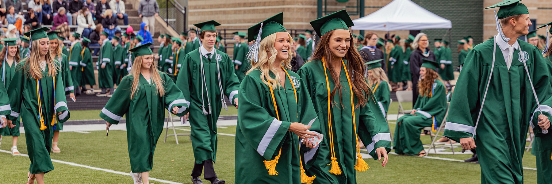 Students walking and smiling at graduation