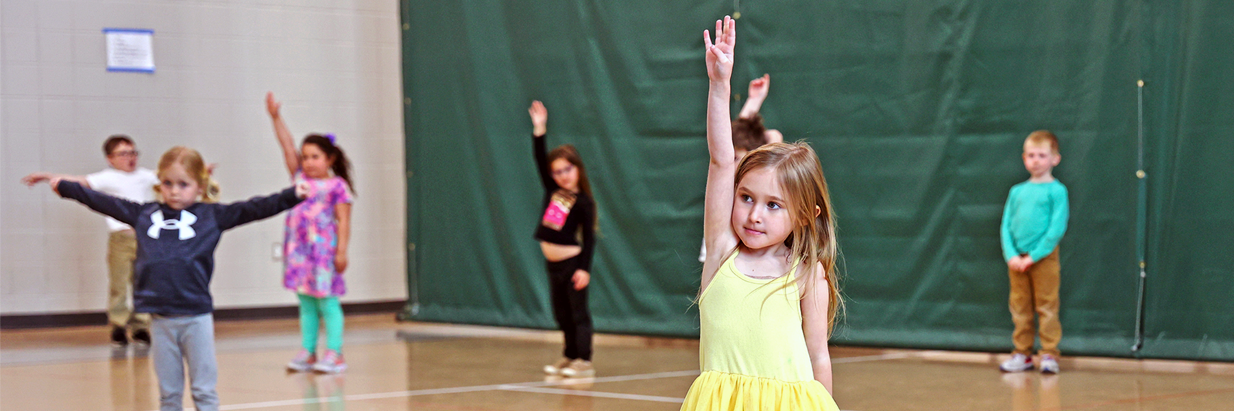 Girl raising hand in gym class