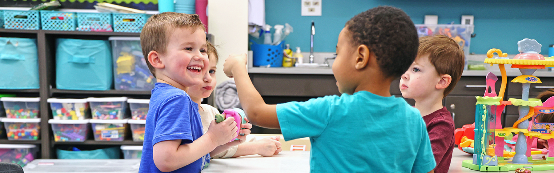 Group of 4 kids playing together in preschool