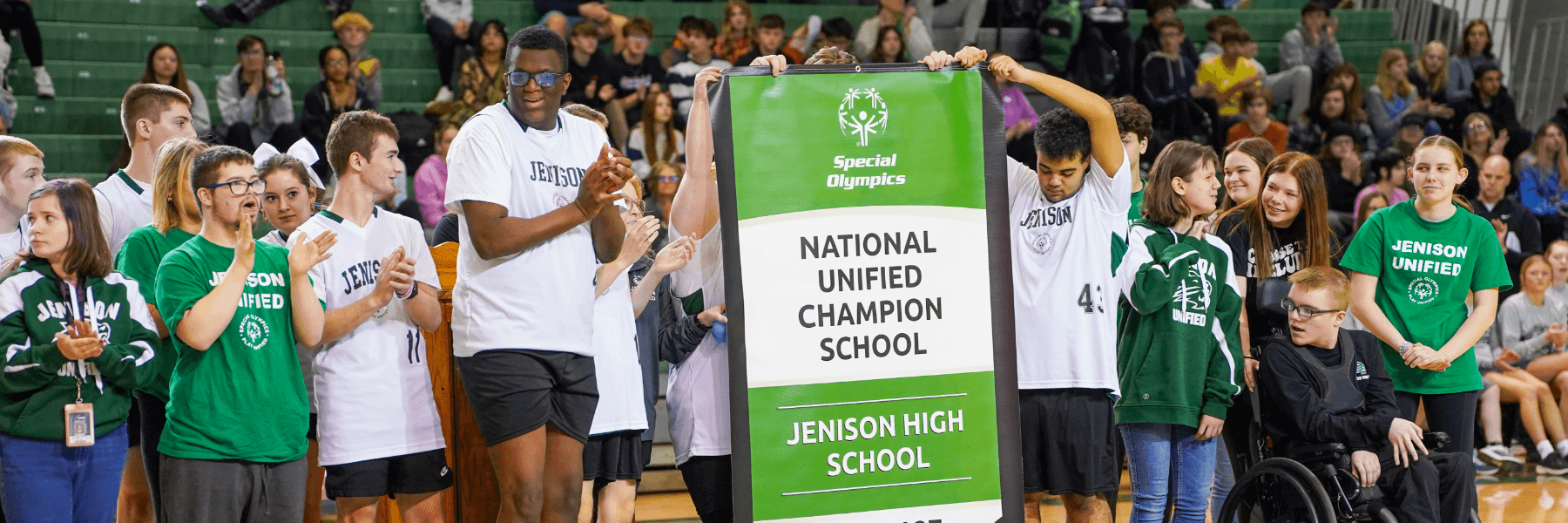 Unified Students holding a banner